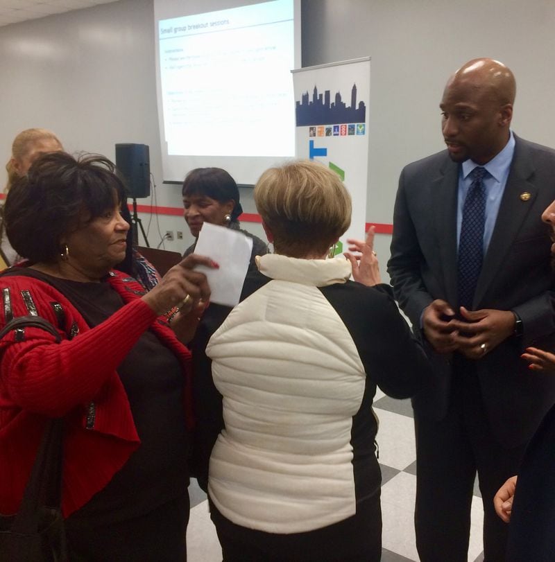 On Wednesday night, Feb. 27, 2019, more than 200 southwest Atlanta residents gathered at the CT Martin Rec Center to give city officials a piece of their mind about promised street repairs and upgrades that have yet to be made. Here, they tell city official Joshua Williams that their street projects need to be funded. Photo by Bill Torpy