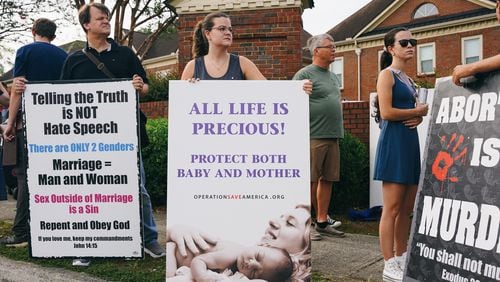 Protesters from Operation Save America canvas outside of an abortion clinic in Forest Park in July. (Olivia Bowdoin for The Atlanta Journal-Constitution)