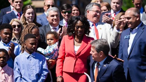 Governor Brian Kemp shares a hug with Chenelle Mosley after signing a bill into law during the Children, Family, and School Choice Bill Signing Ceremony on Thursday, May 6, 2021, in Liberty Plaza at the Georgia State Capitol in Atlanta. Governor Kemp signed House Bill 128, Senate Bill 42, Senate Bill 47, Senate Bill 246, and House Bill 606 into law at the event. CHRISTINA MATACOTTA FOR THE ATLANTA JOURNAL-CONSTITUTION