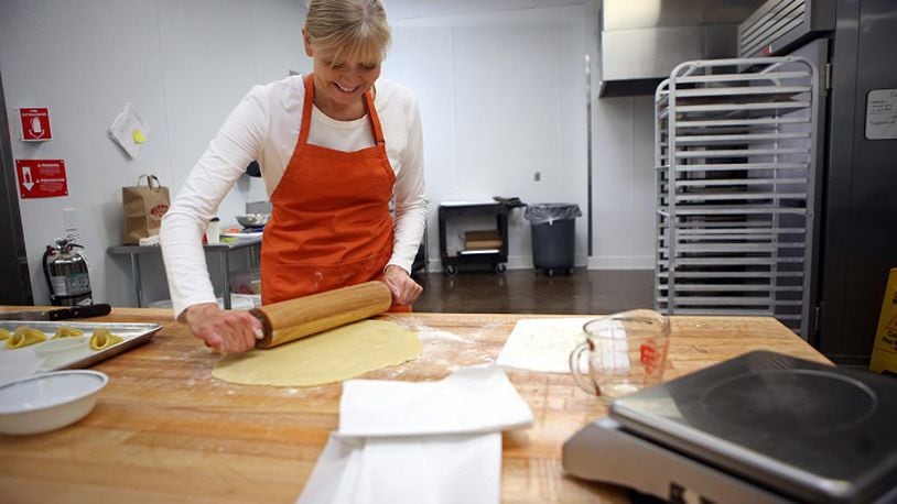 Baker Karen Hansen, owner of Copenhagen Pastry, rolls out the dough to make Napoleon hat cookies at her bakery on Dec. 7, 2015 in Pasadena, Calif. (Genaro Molina/Los Angeles Times/TNS)