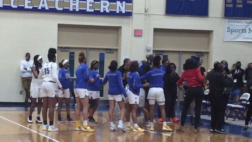 McEachern's player head to the bench for last-minute instructions from coach Phyllis Arthur before their game against Collins Hill in the Class 7A quarterfinals Tuesday at McEachern.