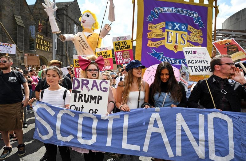 People march holding anti-Trump signs while the U.S. President is visiting Trump Turnberry Luxury Collection Resort in Scotland as people gather to protest during his visit to the United Kingdom on July 14, 2018 in Edinburgh, Scotland.