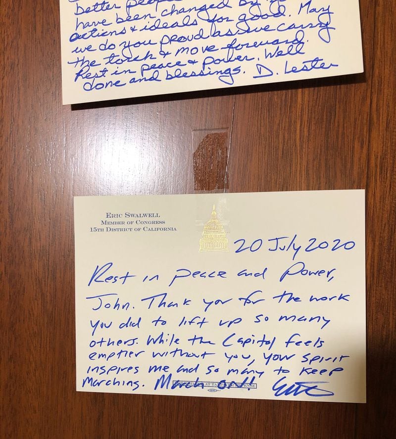 “Rest in peace and power, John,” U.S. Rep. Eric Swalwell, a Democrat from California, wrote in blue ink. “Thank you for the work you did to lift up so many others. While the Capitol feels emptier without you, your spirit inspires me and so many to keep marching. March on!”