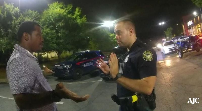 Rayshard Brooks talks with Atlanta police Officer Garrett Rolfe in the Wendy's parking lot before the fatal shooting.