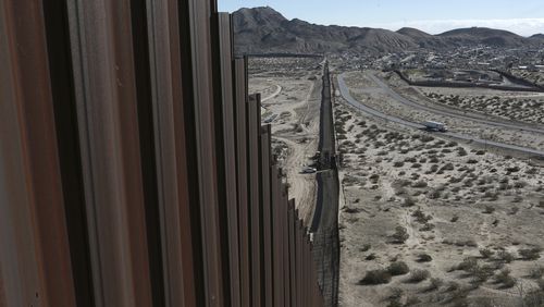 In this Jan. 25, 2017 photo, a truck drives near the Mexico-US border fence, on the Mexican side, separating the towns of Anapra, Mexico and Sunland Park, New Mexico. On Wednesday, President Donald J. Trump promised "immediate construction" would begin on the border wall, telling ABC News that planning is starting immediately. He again vowed that Mexico would pay the U.S. back, though he offered no details. (AP Photo/Christian Torres)