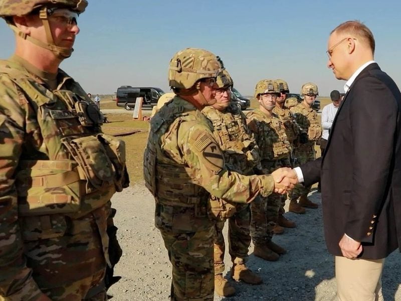 Poland President Andrzej Duda shakes the hand of U.S. Army Brig. Gen. Jeremy Wilson at Fort Stewart, Ga., on Wednesday.
