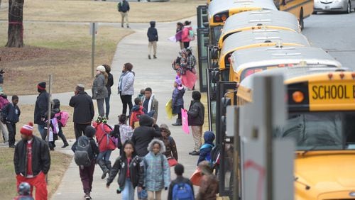 JANUARY 6, 2017  STONE MOUNTAIN Students head to waiting buses as they dismiss early from Woodridge Elementary School Friday January 6, 2017. Students in Cherokee, Forsyth and Cobb counties will not make-up missed days. KENT D. JOHNSON/ KDJOHNSON@AJC.COM