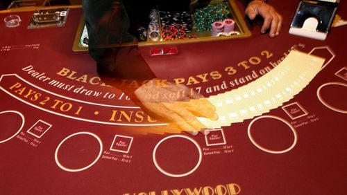 David Delp, a table games dealer, shuffles cards at a blackjack table at the Hollywood Casino in Columbus, Ohio, on August 20, 2014. (Columbus Dispatch photo by Brooke LaValley)