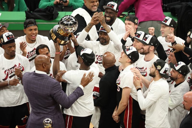 The Miami Heat celebrate with the Bob Cousy Trophy after defeating the Boston Celtics 103-84 in game seven of the Eastern Conference Finals at TD Garden on May 29, 2023, in Boston. (Adam Glanzman/Getty Images/TNS)