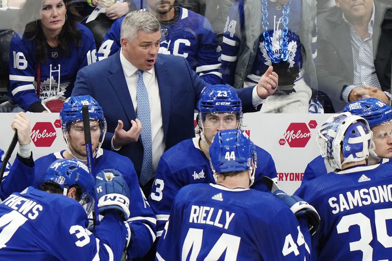 Toronto Maple Leafs coach Sheldon Keefe talks to players on the bench during a timeout during the third period of Game 3 of the team's NHL hockey Stanley Cup first-round playoff series against the Boston Bruins in Toronto on Wednesday, April 24, 2024. (Frank Gunn/The Canadian Press via AP)