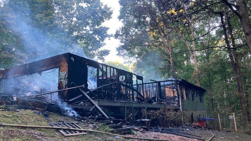Flames were already shooting into the attic when firefighters arrived at the Hillside Drive home in Paulding County, fire officials said.