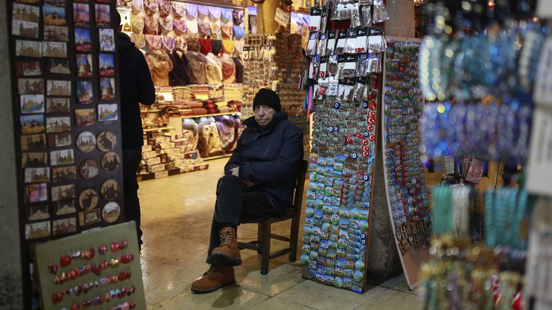 In this Thursday, Jan. 5, 2017 photo, a vendor waits for customers in Istanbul's Grand Bazaar, one of Istanbul's main tourist attractions. Turkey's economy is suffering in the face of a string of extremist attacks -- including this week's nightclub massacre of New Year's revelers, most of them foreigners -- and uncertainty following the failed coup in July against President Recep Tayyip Erdogan that saw more than 270 people killed. (AP Photo/ Emrah Gurel)