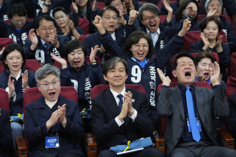 Cho Kuk, center, leader of the South Korean Rebuilding Korea Party, and his party members react as they watch a local media's results of exit polls for parliamentary election on television at the National Assembly in Seoul, South Korea, Wednesday, April 10, 2024. (AP Photo/Ahn Young-joon)