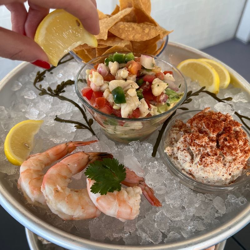 Message in a Bottle serves a small seafood tower that features jumbo shrimp cocktail, smoked fish dip and ceviche. Courtesy of Message in a Bottle