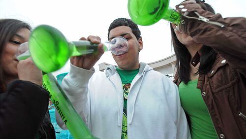 From left, Jennifer Mendez, William Zapata and Amanda Onate drink a toast during Smyrna St. Patrick's Day Festival at Smyrna Market Village in this 2010 file photo.