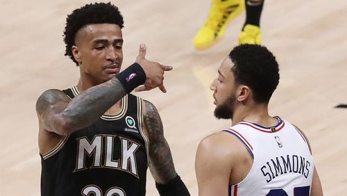 Hawks forward John Collins reacts to hitting a three pointer against Philadelphia 76ers guard Ben Simmons during the fourth quarter of a 103-100 victory over the 76ers in Game 4 of the Eastern Conference semifinals Monday, June 14, 2021, in Atlanta.  (Curtis Compton / Curtis.Compton@ajc.com)