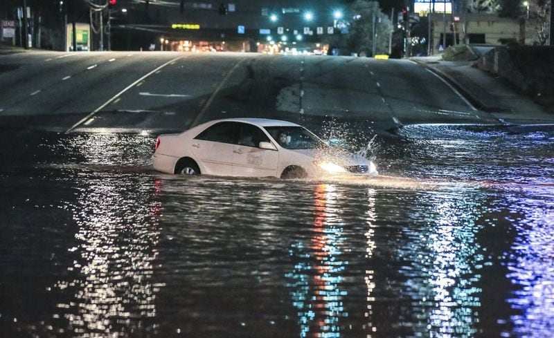 This driver ignored road closed signs and preceded to drive into deep water on Buford Highway on March 7, 2018. She successfully retreated. Buford Highway was flooded just north of I-285 in DeKalb County because of a massive water main break. JOHN SPINK/JSPINK@AJC.COM