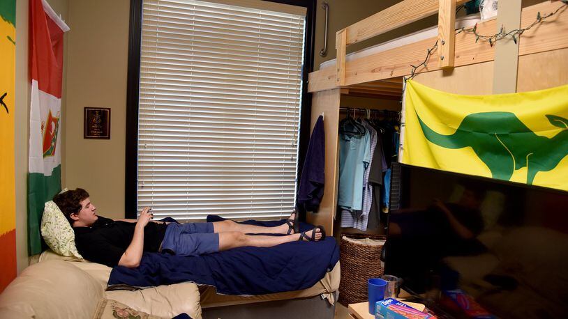 Georgia Tech student Clark Jacobs hangs out in his room at the Kappa Sigma fraternity house on Thursday, Aug. 25, 2016. Jacobs is back in school after cracking his skull in January 2015, when he fell out of his bunk bed. The mechanical engineering student isn’t taking any chances and now sleeps on a bed below his assigned loft. BRANT SANDERLIN/BSANDERLIN@AJC.COM