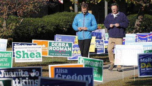 Voters walk through a sea of campaign signs at a polling station in Richmond, Va., Tuesday, Nov. 5, 2019. All seats in the Virginia House of Delegates and State senate are up for election.