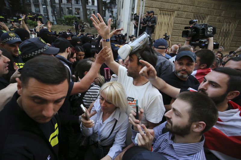 Demonstrators argue with police that blocked them during an opposition protest against "the Russian law" near the Parliament building in Tbilisi, Georgia, on Wednesday, May 1, 2024. Protesters denounce the bill as "the Russian law" because Moscow uses similar legislation to stigmatize independent news media and organizations critical of the Kremlin. (AP Photo/Zurab Tsertsvadze)