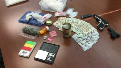 A traffic stop in Douglas County led authorities to 1.6 pounds of methamphetamine, marijuana, two handguns and about two dozen Xanax tablets.