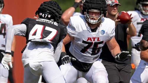 Falcons offensive tackle Kaleb McGary (76) blocks linebacker Arnold Ebiketie (47) during training camp at the Falcons Practice Facility, Friday, August 5, 2022, in Flowery Branch, Ga. (Jason Getz / Jason.Getz@ajc.com)