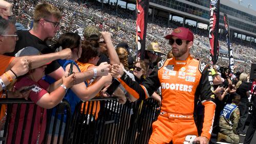 Chase Elliott, right, greets fans during driver introductions before a NASCAR Cup Series auto race at Texas Motor Speedway in Fort Worth, Texas, Sunday, April 14, 2024. (AP Photo/Randy Holt)