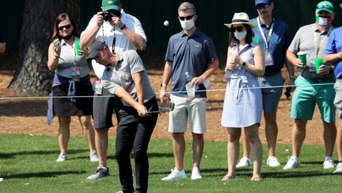 Patrons watch as Rory McIlroy chips to the third green during his practice round for the Masters at Augusta National Golf Club on Wednesday, April 7, 2021, in Augusta. Curtis Compton/ccompton@ajc.com