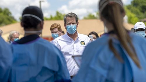 Georgia Gov. Brian Kemp speaks with healthcare workers while touring a community COVID-19 testing site in Gainesville, Friday, May 15, 2020. (ALYSSA POINTER / ALYSSA.POINTER@AJC.COM)
