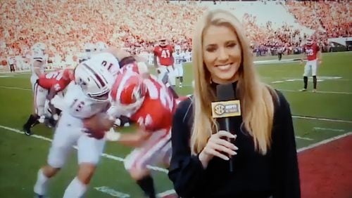 UGA football player Prather Hudson (entangled with UMass player Josiah Johnson) prepares to bump into Laura Rutledge of the SEC Network during last Saturday's game in Athens. (Screenshot via Laura M Rutledge twitter)