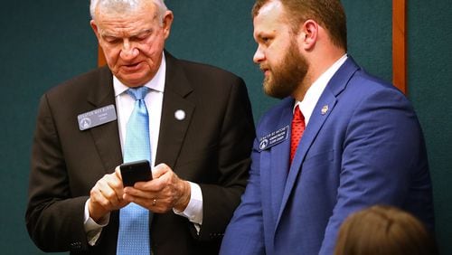 State Sen. Max Burns (left), chairman of the Senate Ethics Committee, has proposed legislation that would make the printed words on ballots the official vote instead of bar codes that are used now but are unreadable by the human eye. CURTIS COMPTON