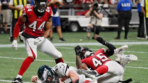 Falcons linebackers Vic Beasley (44) and Deion Jones (45) stopped Philadelphia Eagles quarterback Carson Wentz (11) short of the goal line when the Eagles attempted their first two point conversion.  Bob Andres / robert.andres@ajc.com