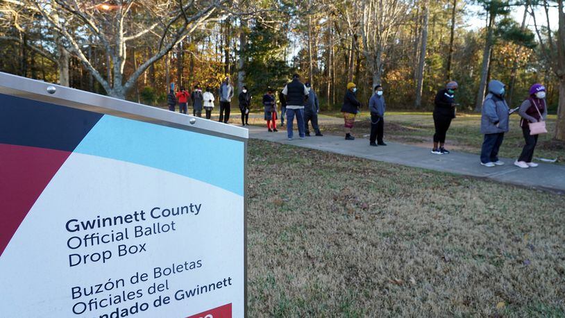 Voters stand in line to cast their ballots during the first day of early voting in the U.S. Senate runoffs at Lenora Park, December 14, 2020, in Atlanta. (Tami Chappell/AFP/Getty Images/TNS)