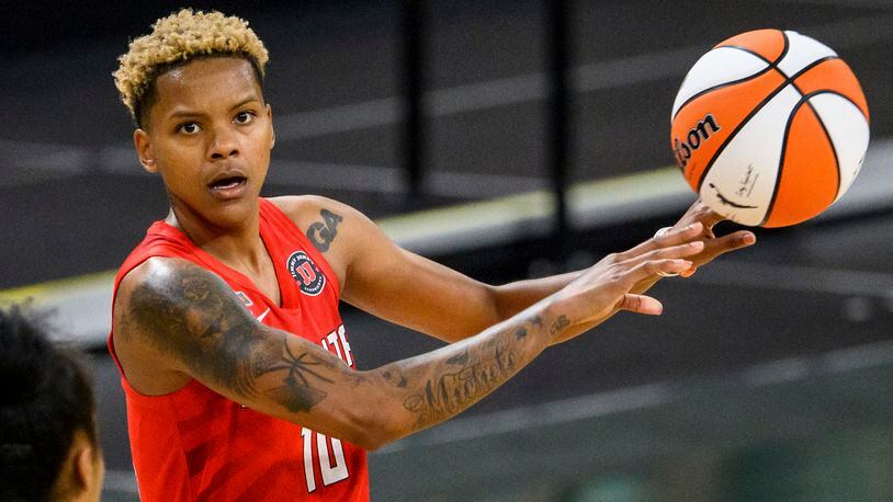 Dream guard Courtney Williams (10) passes the ball during a game against the Dallas Wings, Thursday, May 27, 2021, in College Park, Ga. (AP Photo/Danny Karnik)