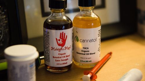 A bottle of cannabis oil used by Janea Cox to treat her daughter Haleigh, 7, at their home in Forsyth, Ga. The Coxes must still travel to Colorado to obtain the medical marijuana used to treat Haleigh. BITA HONARVAR/SPECIAL