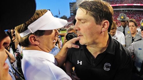Georgia head football coach Kirby Smart is congratulated by South Carolina's Will Muschamp after the game Nov. 4, 2017,  at Sanford Stadium in Athens.