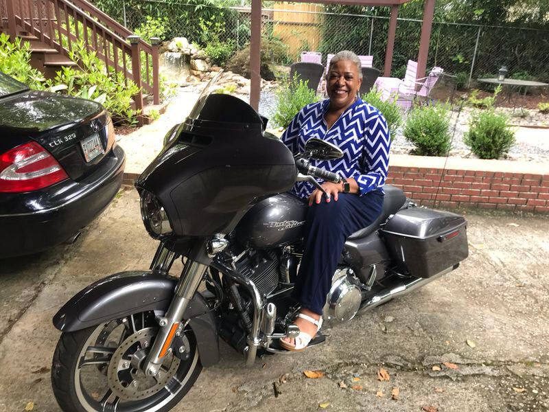 She is wearing her work clothes only because I asked her to pose on her 2014 Harley Street Glide special during lunch hour. She is usually dressed with much more street panache when she is actually riding.
