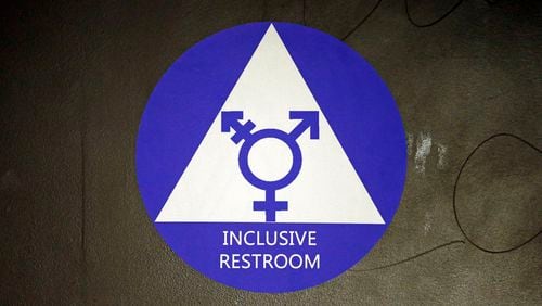 A new sticker designates a gender neutral bathroom at Nathan Hale High School Tuesday, May 17, 2016, in Seattle. President Obama's directive ordering schools to accommodate transgender students has now prompted a lawsuit by 11 states, but since 2012 Seattle has mandated that transgender students can use the bathrooms and locker rooms of their choice. (AP Photo/Elaine Thompson)