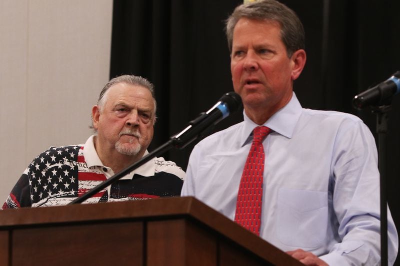 DO NOT USE AS PRIMARY PHOTO
June 15, 2019 Marietta- Cobb County Sheriff Neil Warren (left) looks on while Georgia Governor Brian Kemp (right) addresses the crowd during the 30th annual Cobb Sheriff's Corn Boilin' at Jim Miller Park in Marietta, Georgia on Monday, July 15, 2019. Warren claims that the Corn Boilin', his largest political fundraiser, raises $10,000 a year for the Cobb Youth Museum, but the sheriff's financial disclosures show that he's given significantly less. Christina Matacotta/Christina.Matacotta@ajc.com