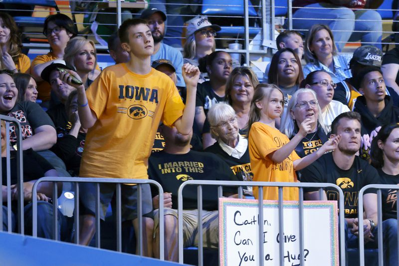 Iowa fans cheer the Indiana Fever and player Caitlyn Clark, as they play against the Dallas Wings during an WNBA basketball game in Arlington, Texas, Friday, May 3, 2024. (AP Photo/Michael Ainsworth)