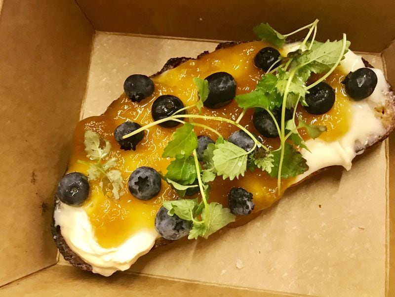 Ole Reliable offers savory and sweet open-faced sandwiches, aka toast, for breakfast and lunch. Pictured is one featuring Italian mascarpone cheese and peach preserves with blueberries and fresh mint on toasted bread made by local bakery Root Baking Co. LIGAYA FIGUERAS / LFIGUERAS@AJC.COM.