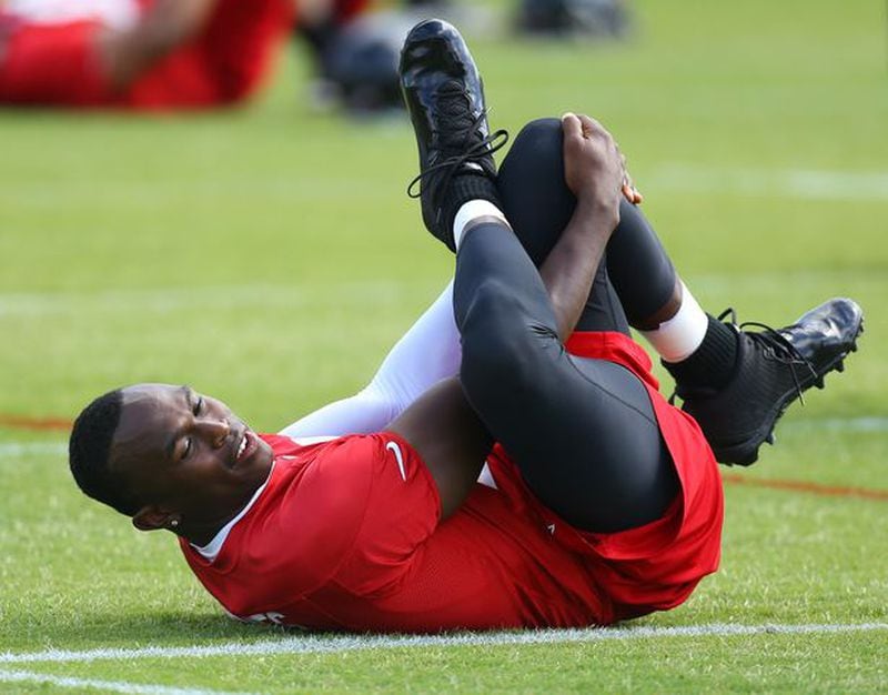 Falcons wide receiver Julio Jones stretches during team practice on Tuesday, June 10, 2014, in Flowery Branch. His return will be a big story on HBO Hard Knocks this summer. (Curtis Compton)