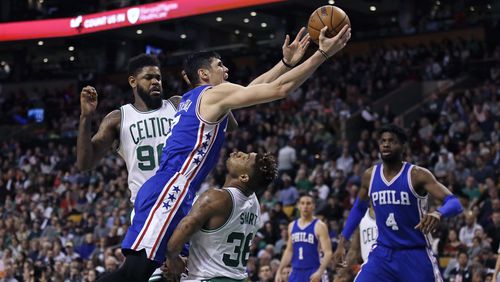 Philadelphia 76ers forward Ersan Ilyasova collides with Boston Celtics guard Marcus Smart (36) on a drive to the basket during the second half of an NBA basketball game in Boston, Wednesday, Feb. 15, 2017. The Celtics defeated the 76ers 116-108. (AP Photo/Charles Krupa)