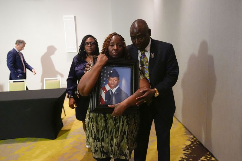 Attorney Ben Crump walks with Chantemekki Fortson, mother of Roger Fortson, a U.S. Navy airman, as they leave a news conference about his death, Thursday, May 9, 2024, in Ft. Walton Beach, Fla. Fortson was shot and killed by police in his apartment on May 3, 2024. (AP Photo/Gerald Herbert)
