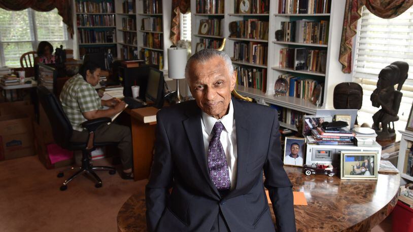 Portrait of C.T. Vivian at his home library as his daughter Charisse Thornton (background) and Dawnn Mitchell work on checking inventory on Tuesday, July 25, 2017. The National Monuments Foundation will be acquiring and managing the world-class library of Atlanta Civil Rights icon, C.T. Vivian. The library will be housed in the new Cook Park in Vine City. Vivian lived in the same Vine City neighborhood that will border Cook Park where his library is to be constructed under a 101-foot Peace Column. The 6,000 volume C.T. Vivian Library is one of the most impressive private collections in the city. HYOSUB SHIN / HSHIN@AJC.COM