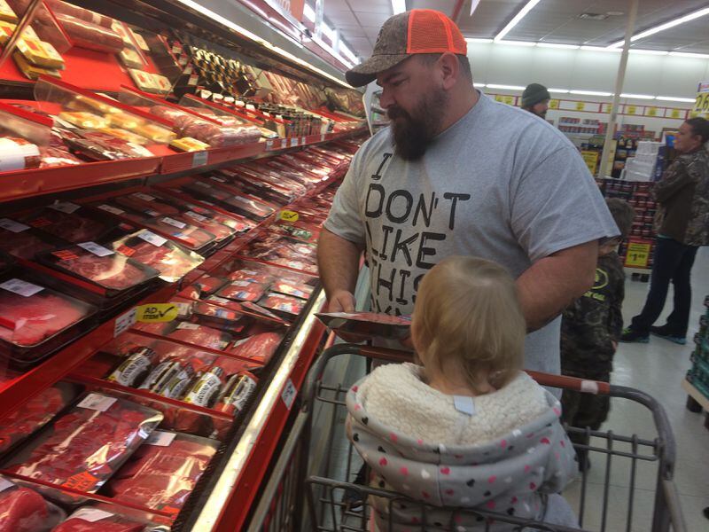 Jason Banks shops with his daughter Taytem at the Save-a-Lot grocery in Blue Ridge