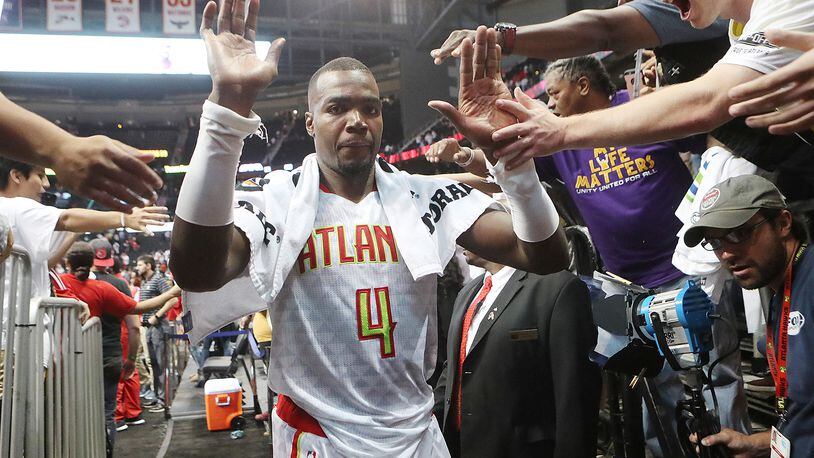 October 27, 2016 ATLANTA: Hawks Paul Millsap gets high fives from fans after beating the Wizards 114-99 in the home opener of their NBA basketball game at Philips Arena on Thursday, Oct. 27, 2016, in Atlanta. Curtis Compton /ccompton@ajc.com