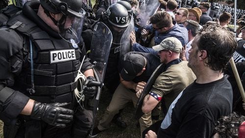 Riot police and alt-right rally members clash on Saturday Aug. 12, 2017 in Lee Park in Charlottesville, Va. (Go Nakamura/Zuma Press/TNS)