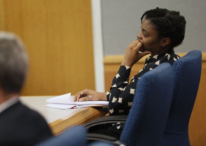 Tiffany Moss listens to testimony during her murder trial for starving to death her 10-year-old stepdaughter in 2013. Bob Andres / bandres@ajc.com