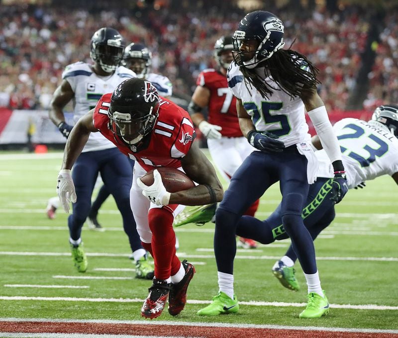  January 14, 2017, Atlanta: Falcons wide receiver Julio Jones scores a touchdown past Seahawks cornerback Richard Sherman to tie the game 7-7 during the first quarter in a NFL football NFC divisional playoff game on Saturday, Jan. 14, 2017, in Atlanta. Curtis Compton/ccompton@ajc.com